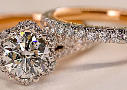 a diamond studded gold ring set with a circle cut center diamond