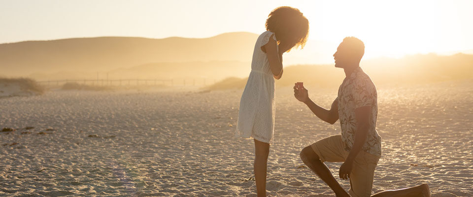 man proposing on beach